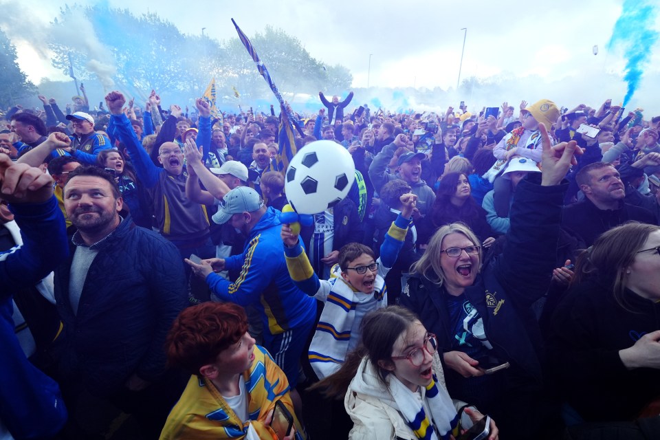 Leeds United fans celebrating promotion outside Elland Road.