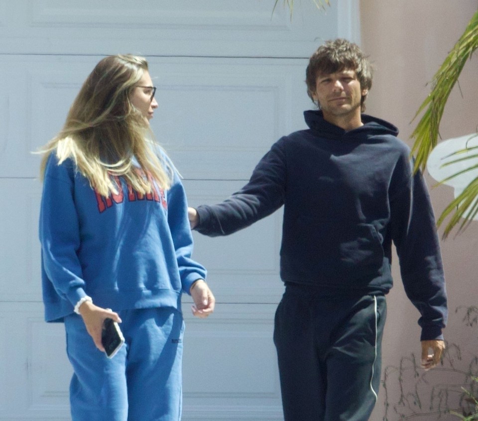 Louis Tomlinson and Zara McDermott walking together.