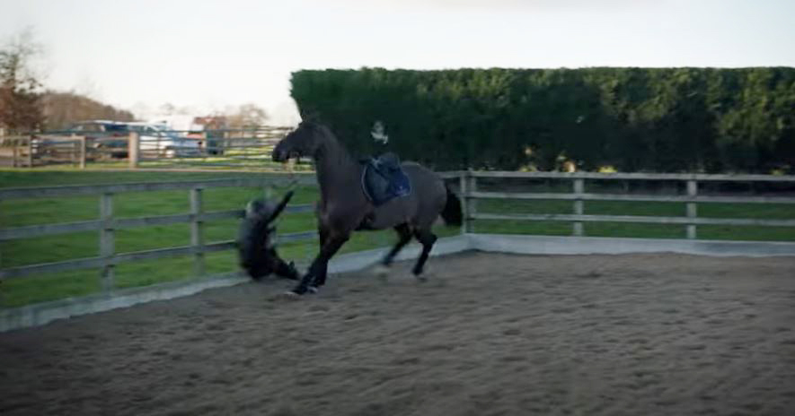 Woman falling off horse.