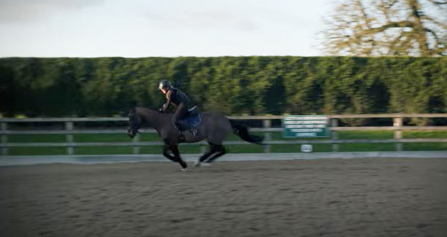 A person falling off a horse.
