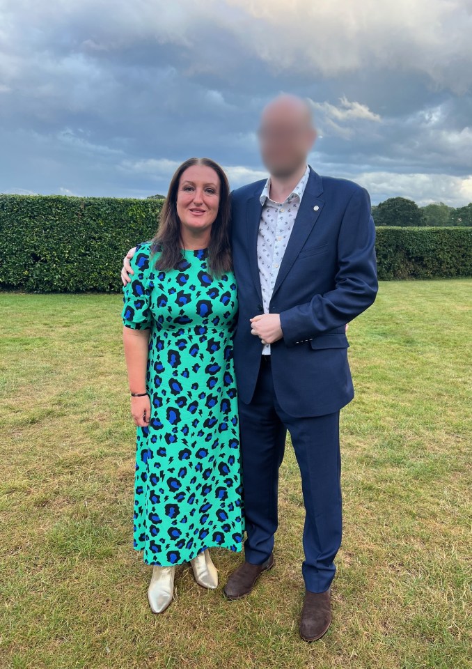 Woman in teal animal print dress and gold boots standing with her husband.
