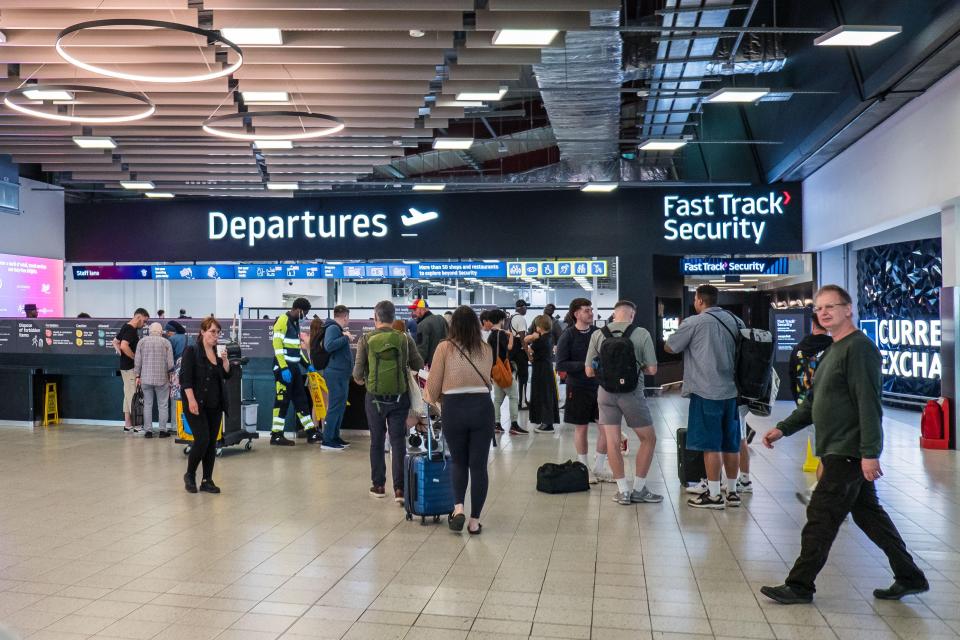 Passengers at Luton Airport departures.