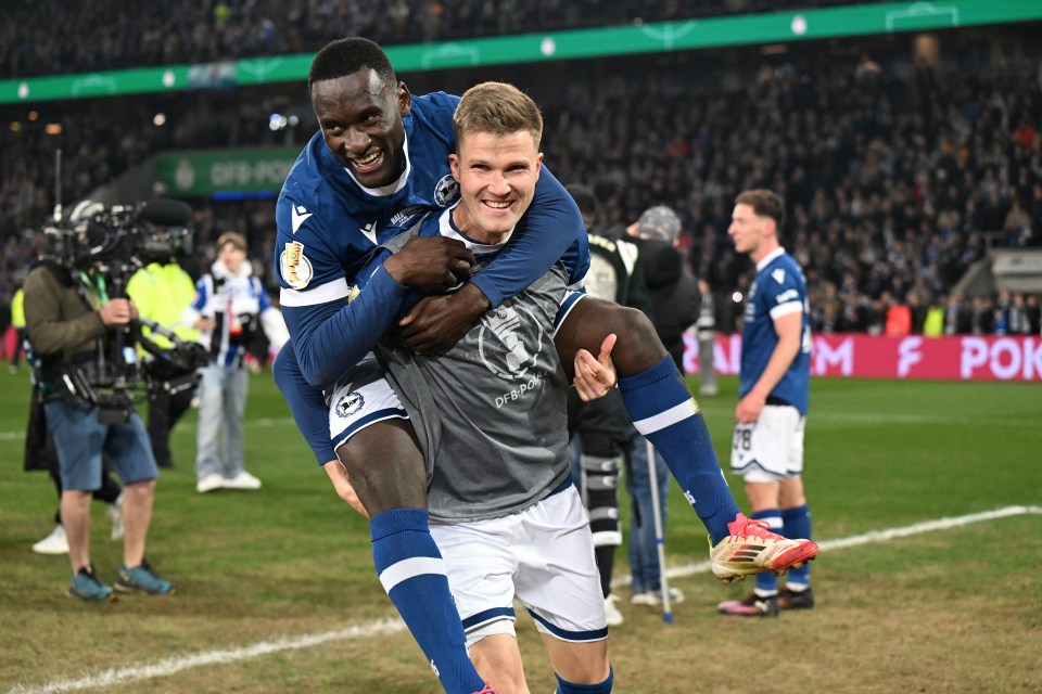 Arminia Bielefeld players celebrating a football match victory.
