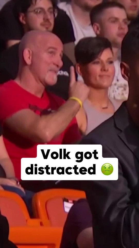 UFC fan and girlfriend engaging in inappropriate behavior during a live broadcast, distracting Alexander Volkanovski.