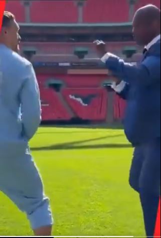 Usyk and Dubois on a field.
