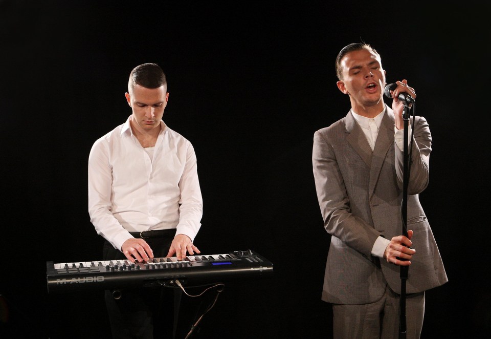 Theo Hutchcraft and Adam Anderson of the band Hurts performing.