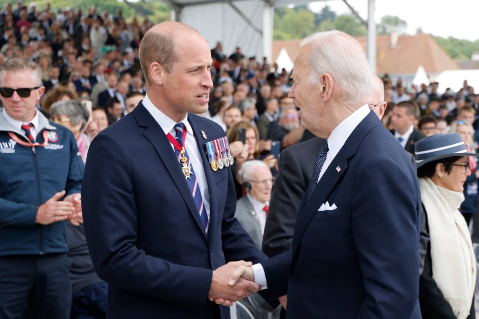 Prince William shaking hands with President Biden at a D-Day ceremony.