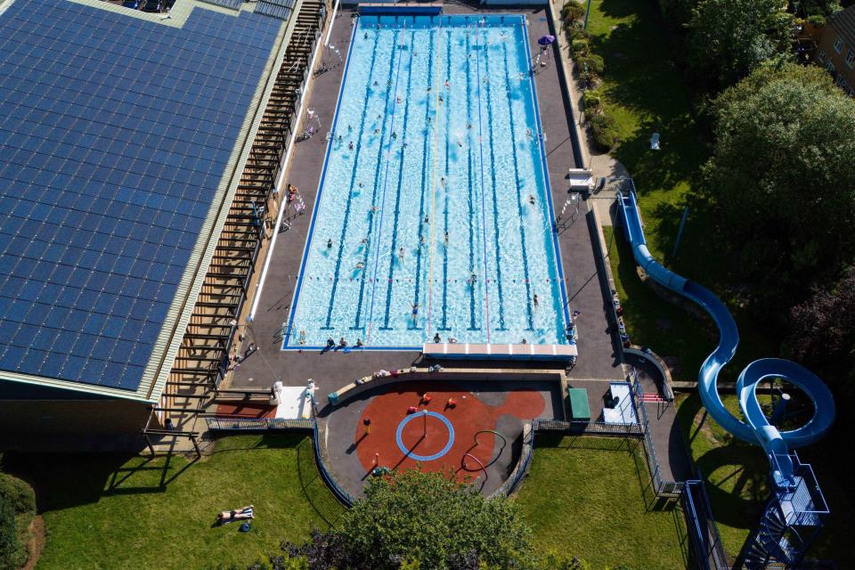 Aerial view of Banbury Lido with many people swimming.