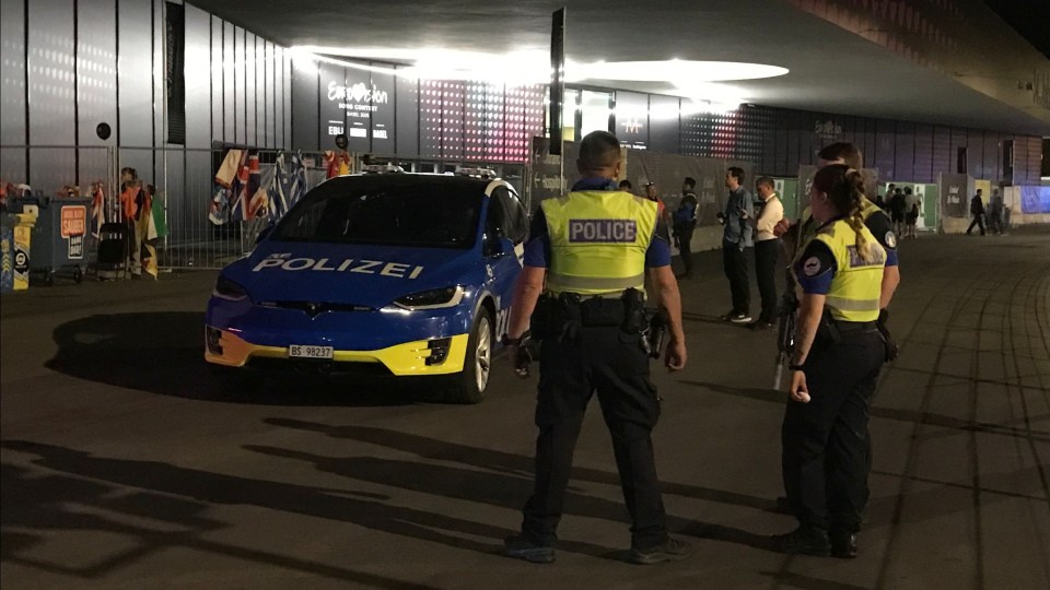 Police detaining protesters at Eurovision Song Contest.