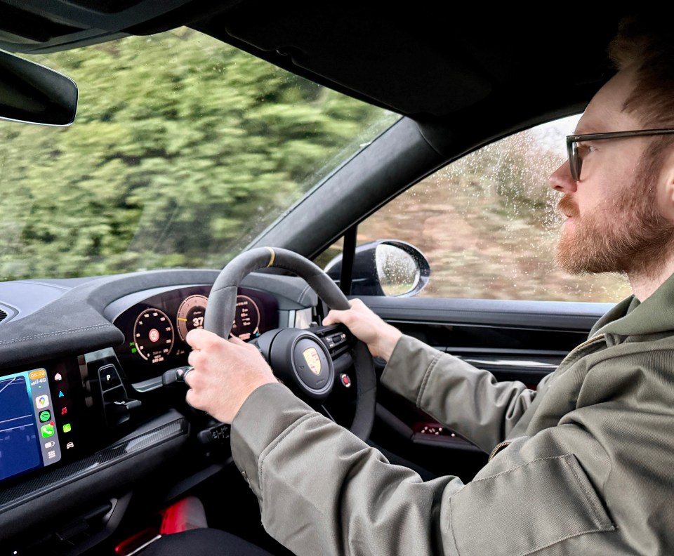 Man driving a Porsche Cayenne.
