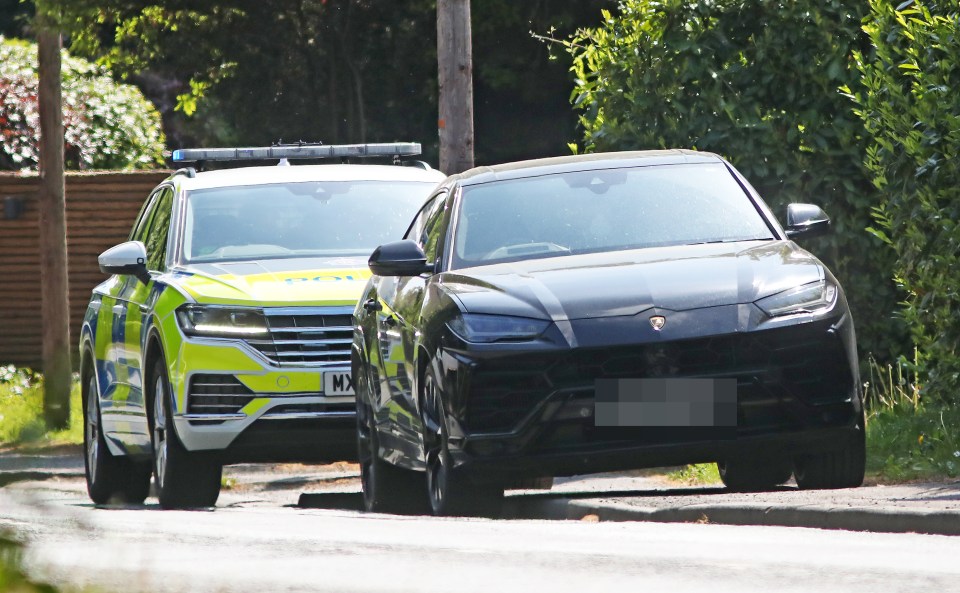 A black Lamborghini Urus stopped by police.