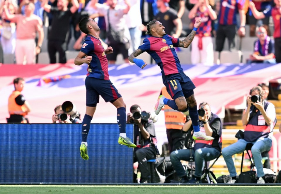 BARCELONA, SPAIN - MAY 11: Raphinha of FC Barcelona celebrates scoring his team's third goal with teammate Ferran Torres during the LaLiga match between FC Barcelona and Real Madrid CF at Estadi Olimpic Lluis Companys on May 11, 2025 in Barcelona, Spain. (Photo by David Ramos/Getty Images)