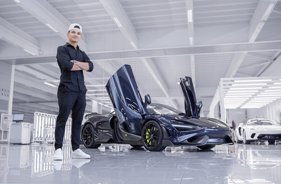 Man standing in front of a McLaren sports car.