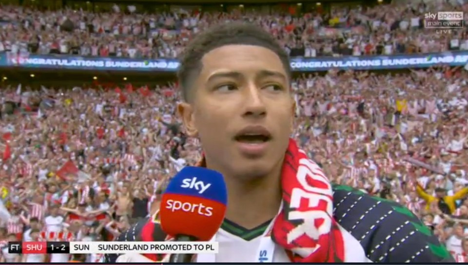 A soccer player being interviewed amidst celebrating fans.
