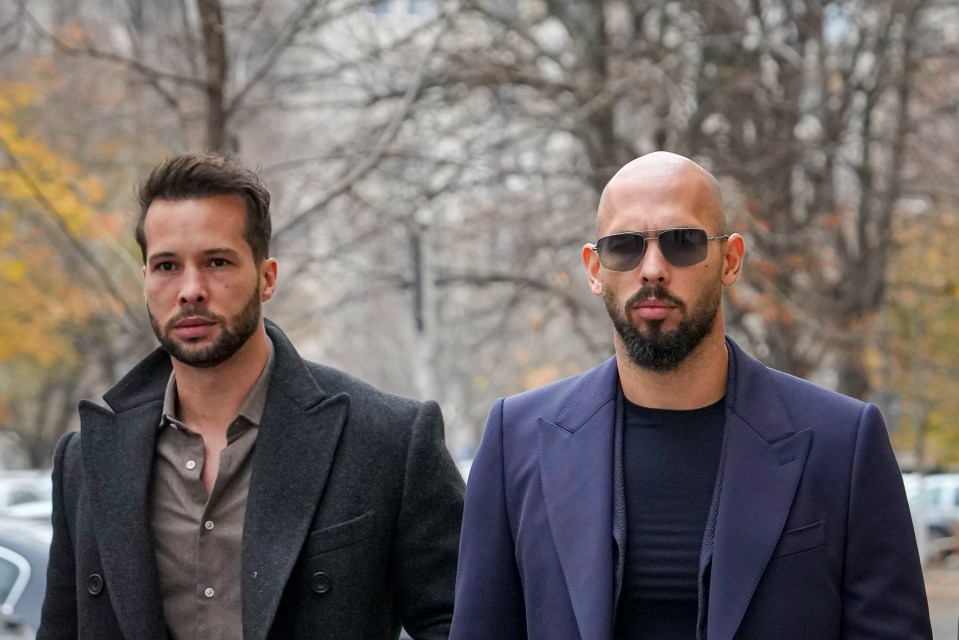 Andrew Tate and his brother Tristan Tate walking in a courthouse.