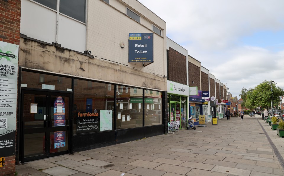 Acomb, York street scene with shops, some of which are closed or for let.