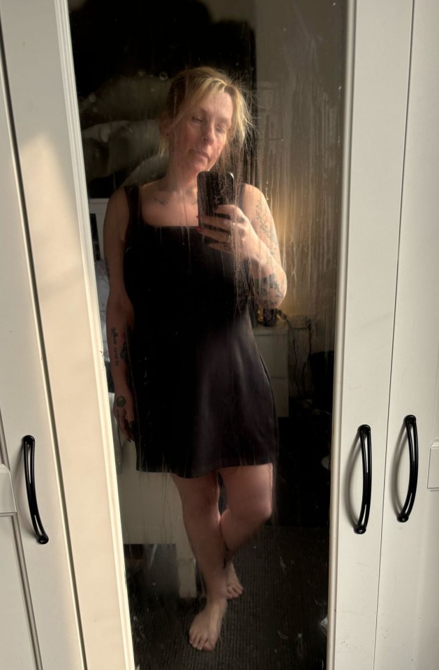 Woman taking a selfie in a mirror.