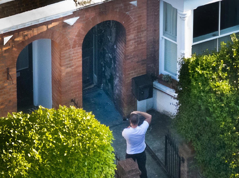 Licensed to London News Pictures. 12/05/2025. London, UK. A photographer gathers evidence from the fire damaged entrance to a property in north London owned by Prime Minister Keir Starmer. Fire officers have extinguished a fire at a property belonging to the prime minister in North London. The house is rented out . Photo credit: Peter Macdiarmid/LNP
