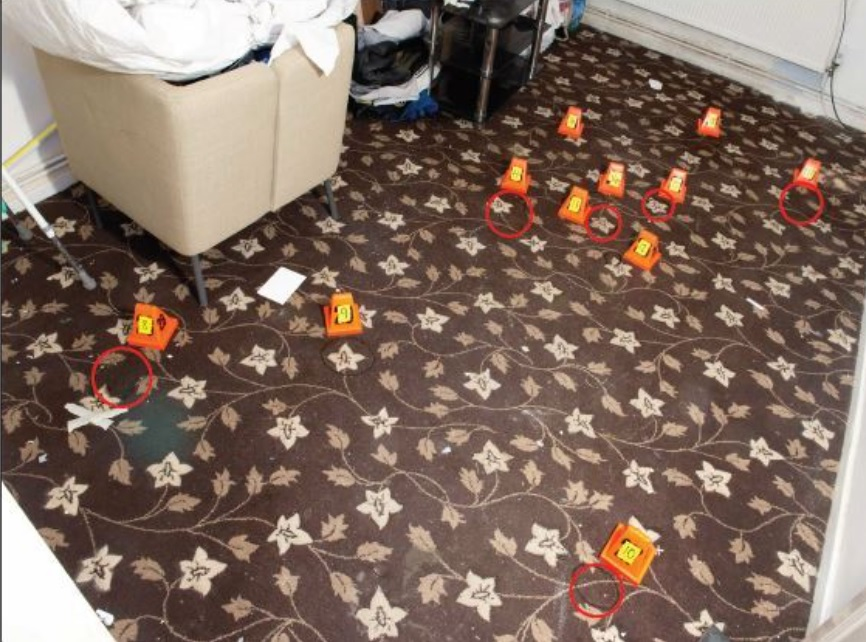 Forensic markers on a bedroom carpet.