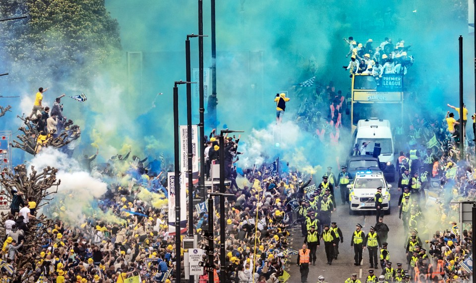 Leeds United championship parade with fans lining the streets.