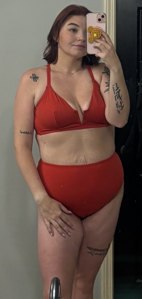 Woman in red bikini taking a selfie.
