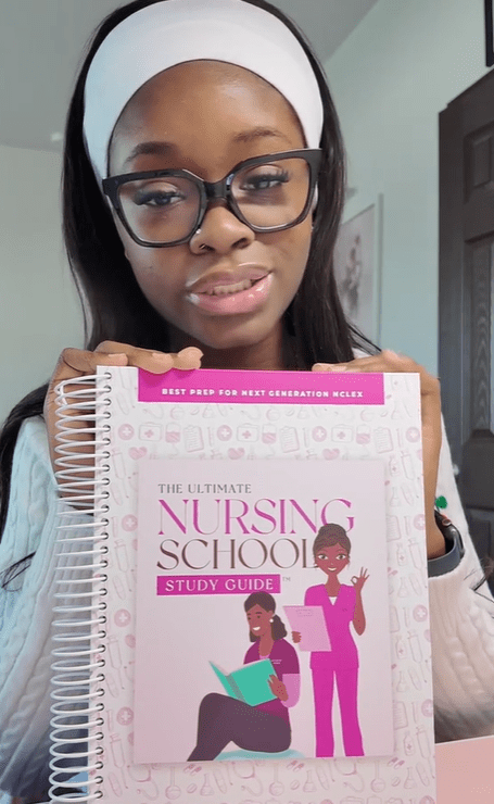 Person holding "The Ultimate Nursing School Study Guide."