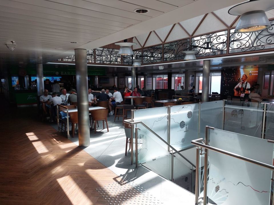 Passengers relaxing in a ferry lounge.