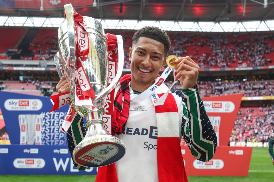 Jobe Bellingham of Sunderland holding a trophy and winner's medal.