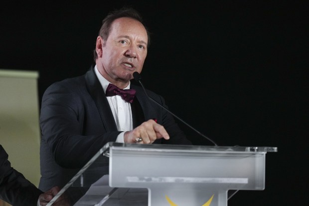 Kevin Spacey speaking at a podium.