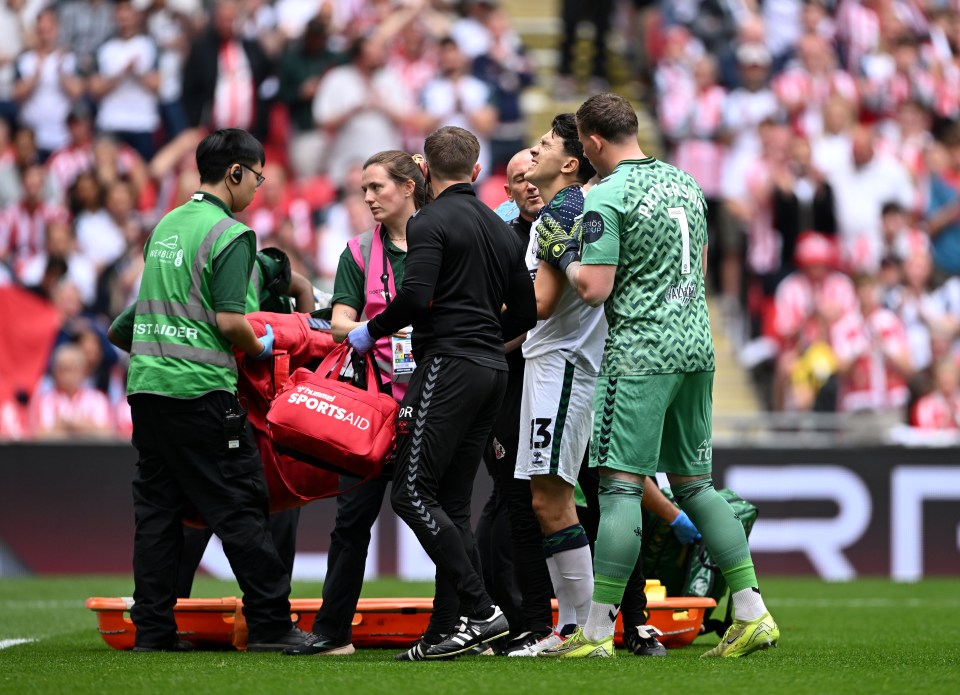Luke O'Nien of Sunderland receiving medical attention on the field.