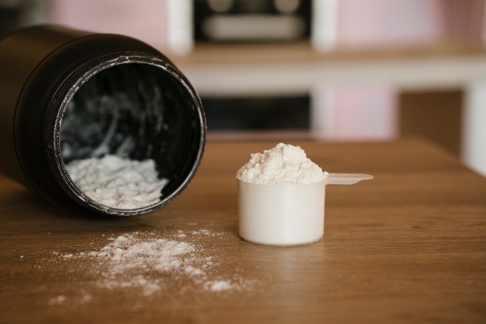 Collagen powder in a scoop next to an open container.