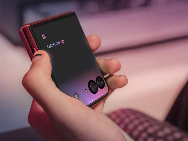 A hand holding a Motorola Razr 60 Ultra phone displaying &quot;Catch me up&quot;.