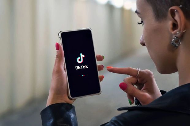 An image collage containing 1 images, Image 1 shows Woman using TikTok app on her phone