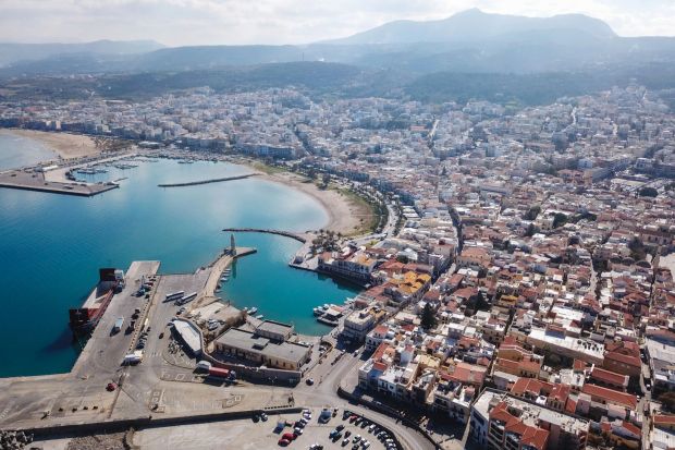 An image collage containing 1 images, Image 1 shows Aerial view of Heraklion, Crete, showing the city's harbor, coastline, and surrounding buildings