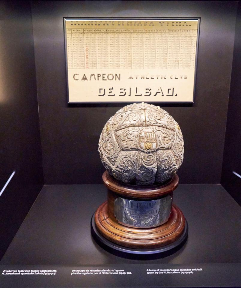 Ornate silver soccer ball on wooden base, displayed with a historical league record chart; FC Athletic Bilbao.