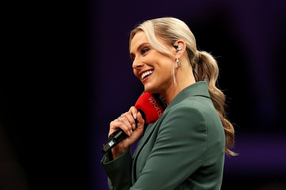 Emma Paton, Sky Sports presenter, holding a microphone.