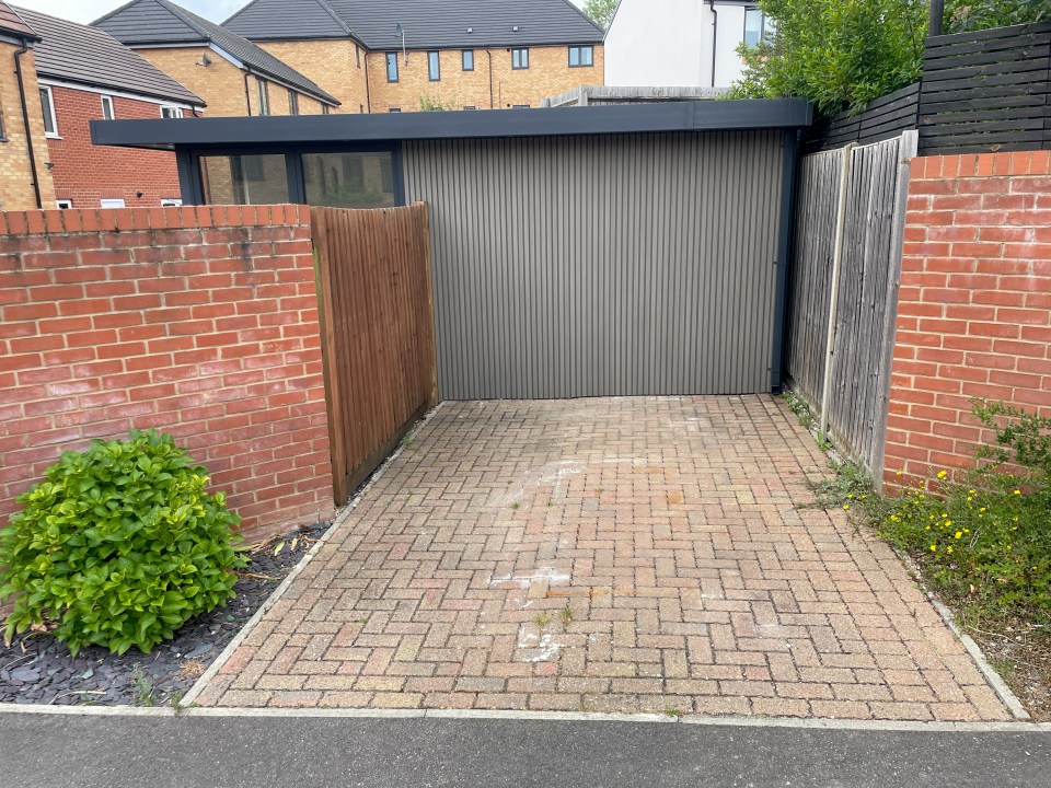 Home gym built on driveway, causing parking dispute.