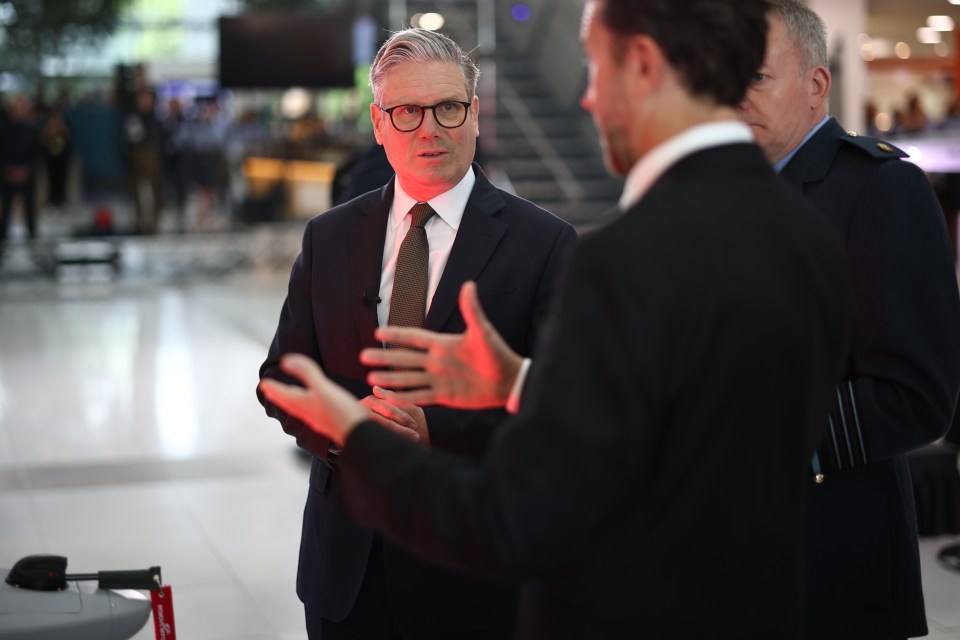 UK Prime Minister Keir Starmer speaking with staff.