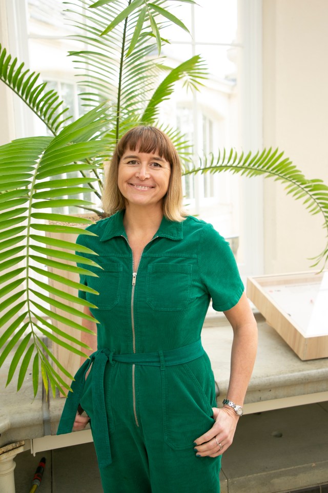 Woman in green jumpsuit at Kew Gardens.