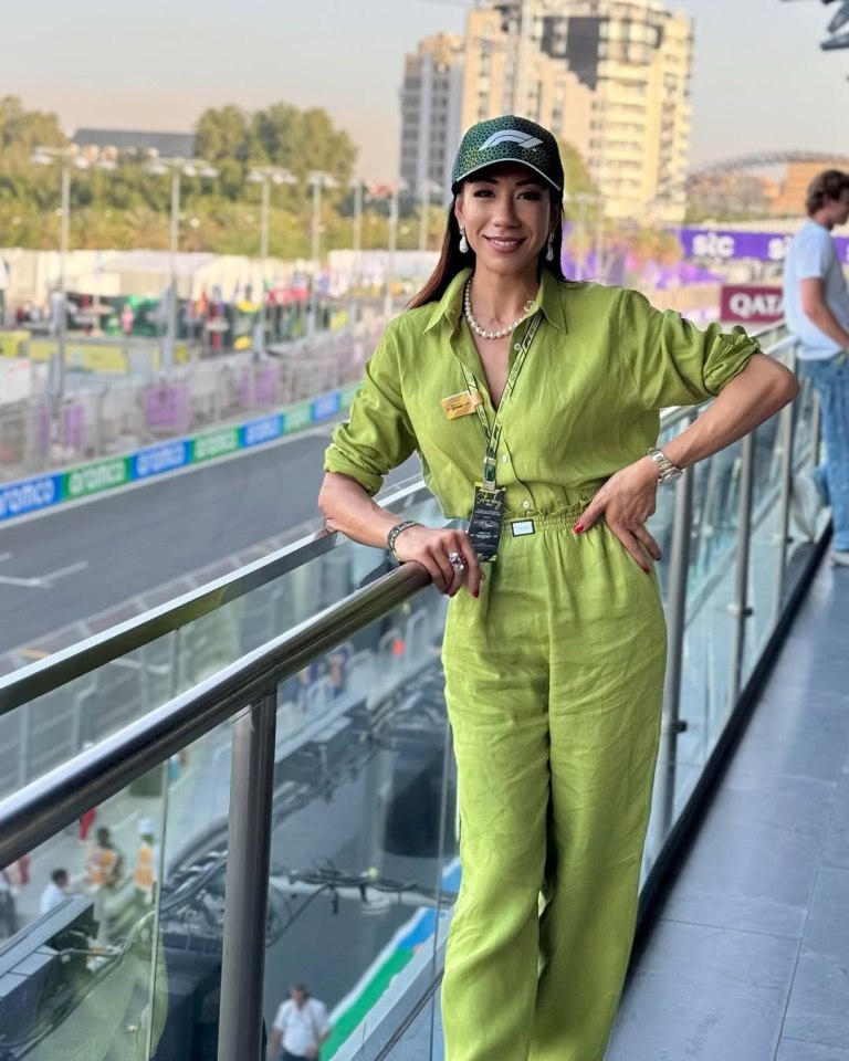 Woman in lime green jumpsuit at a racetrack.