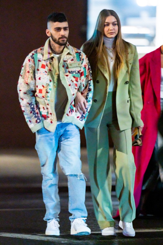 Zayn Malik and Gigi Hadid walking arm in arm.