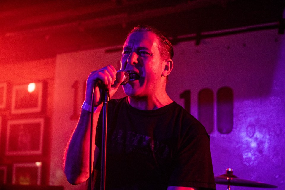 Colin Jerwood of the band Conflict performing on stage.