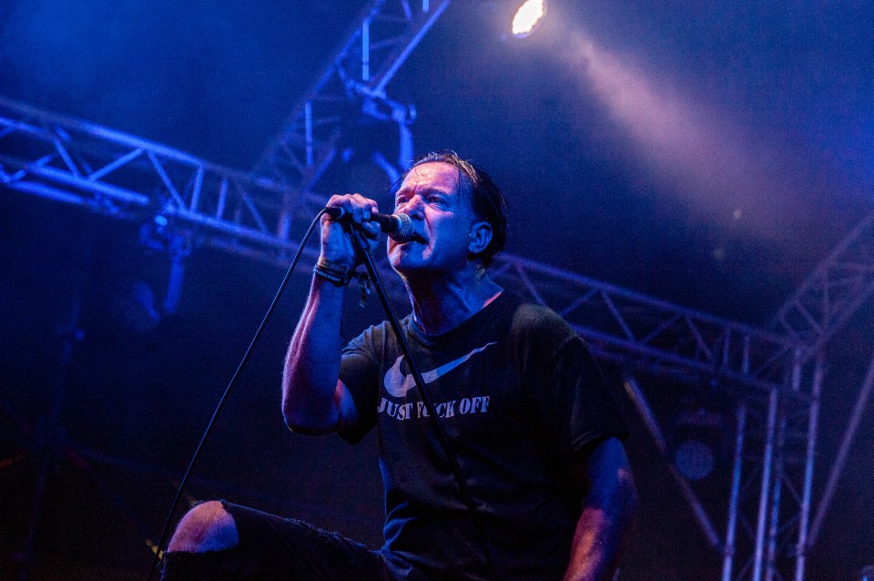 Colin Jerwood of the band Conflict performing on stage.