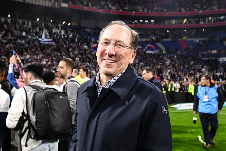 John Textor, president of Olympique Lyonnais, smiling after a soccer match.