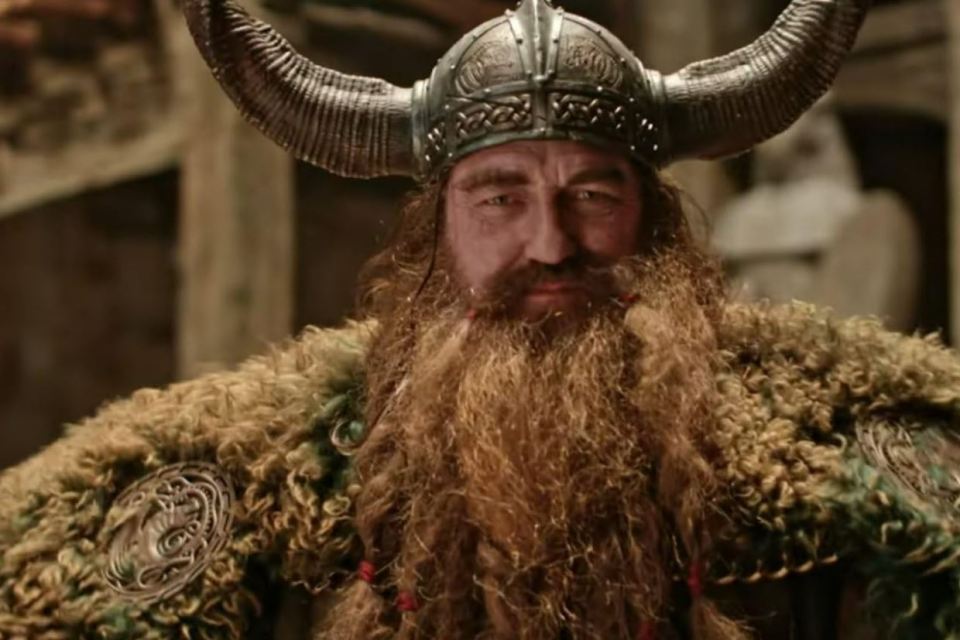 A man with a long beard and Viking helmet.